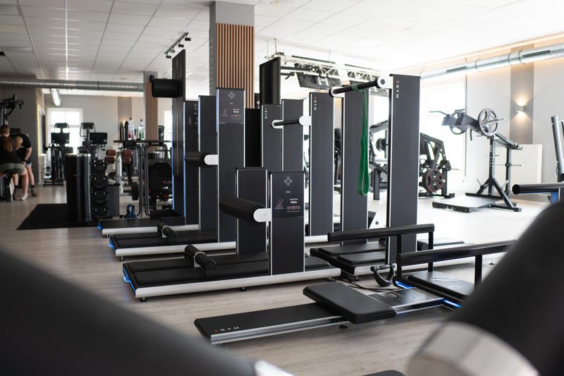 Reihe der EGYM Smart Flex Geräte auf der Trainingsfläche im Fit-Inn Heldenbergen